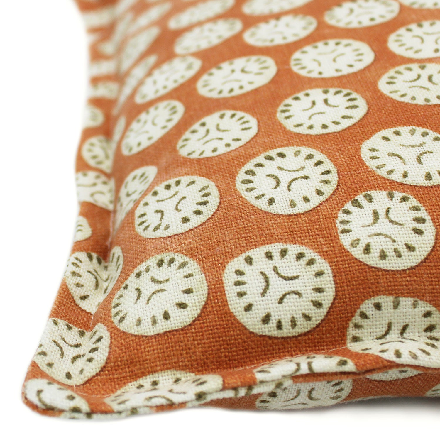A orange, cream and black linen cushion with a all-over repeat pattern.