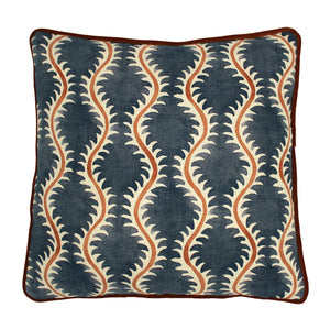 A blue, orange and cream linen cushion with a all-over repeat pattern and linen piping.
