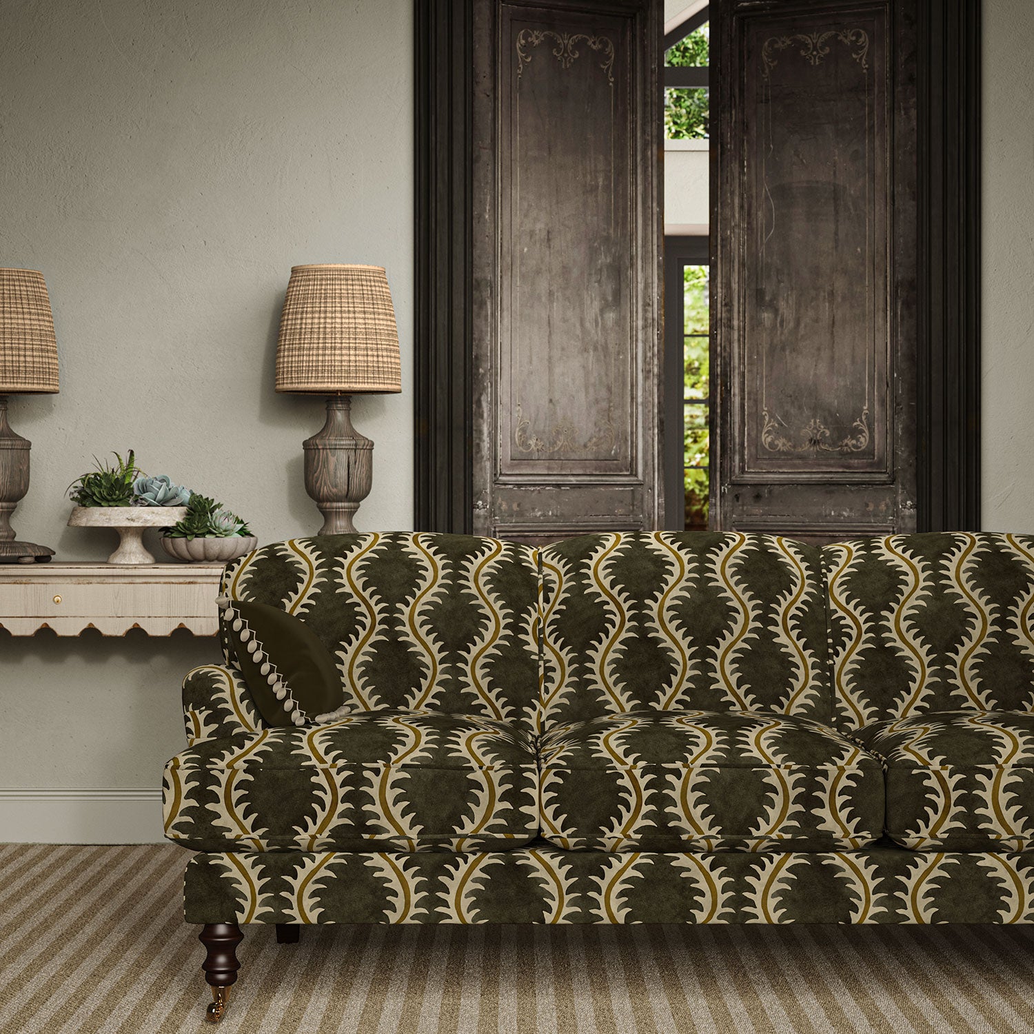 Sofa upholstered in a printed velvet fabric in brown and green featuring a stylized fern pattern.