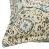 A blue, cream and brown linen cushion with a central motif pattern.