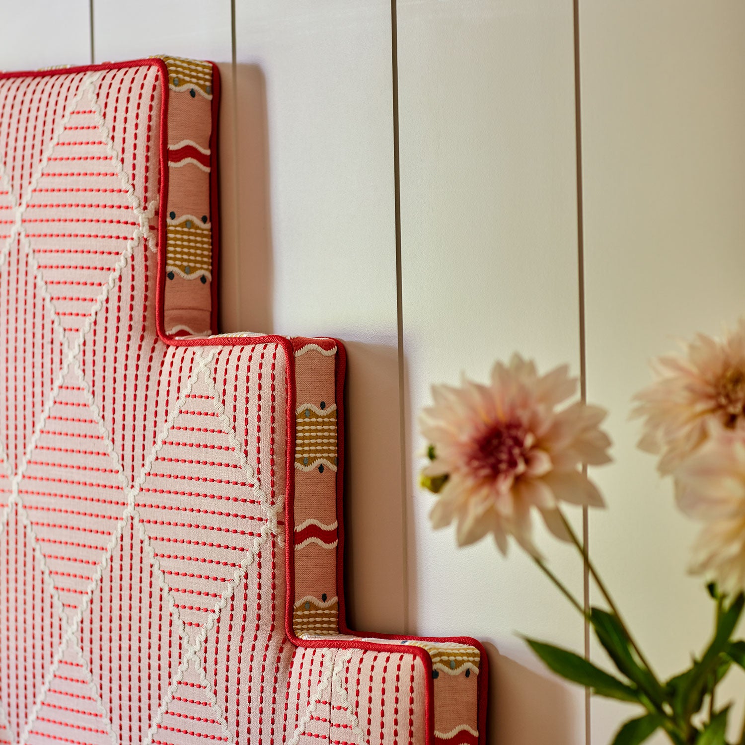 Pink embroidered headboard.