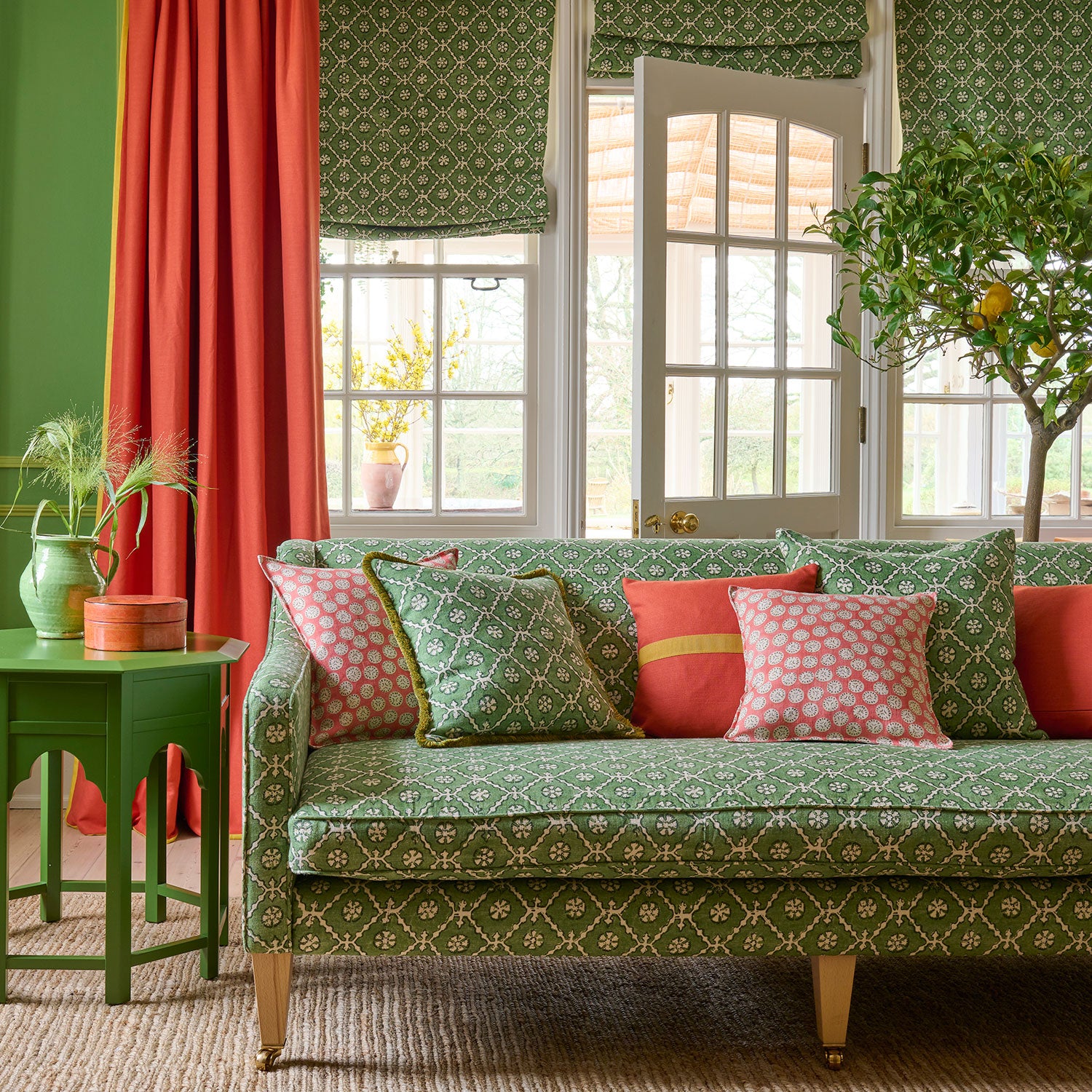 Sofa covered in a linen fabric with a hand block-style pattern in green, black and cream