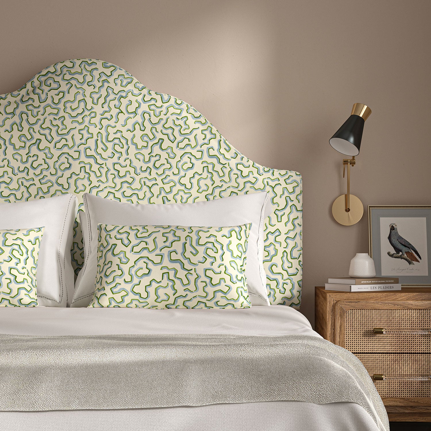 Headboard upholstered in a printed linen fabric in blue, green, and off white featuring a feel of a classic animal print.