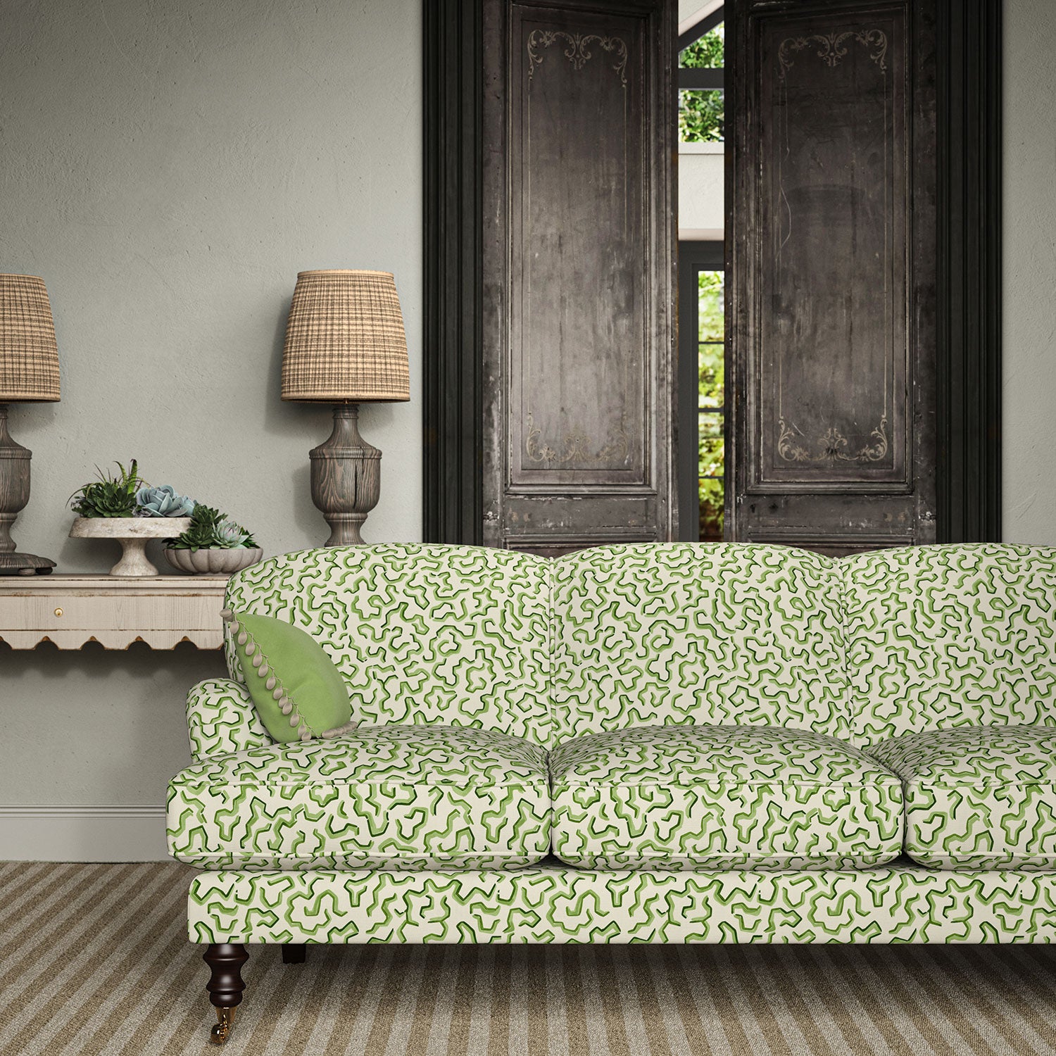 Sofa upholstered in a printed linen fabric in green and off white featuring a feel of a classic animal print.