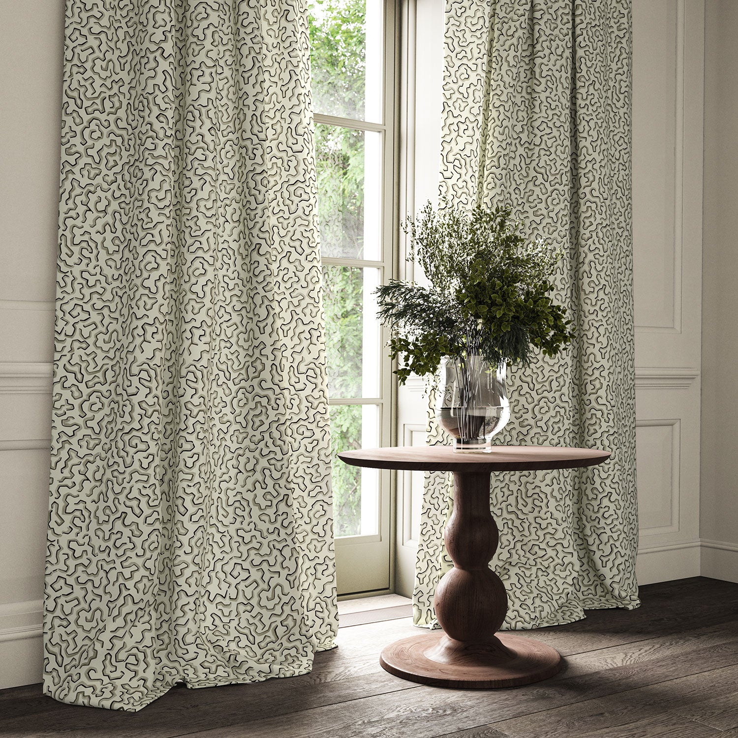Curtains made from a printed linen fabric in black, grey, and off white featuring a feel of a classic animal print.