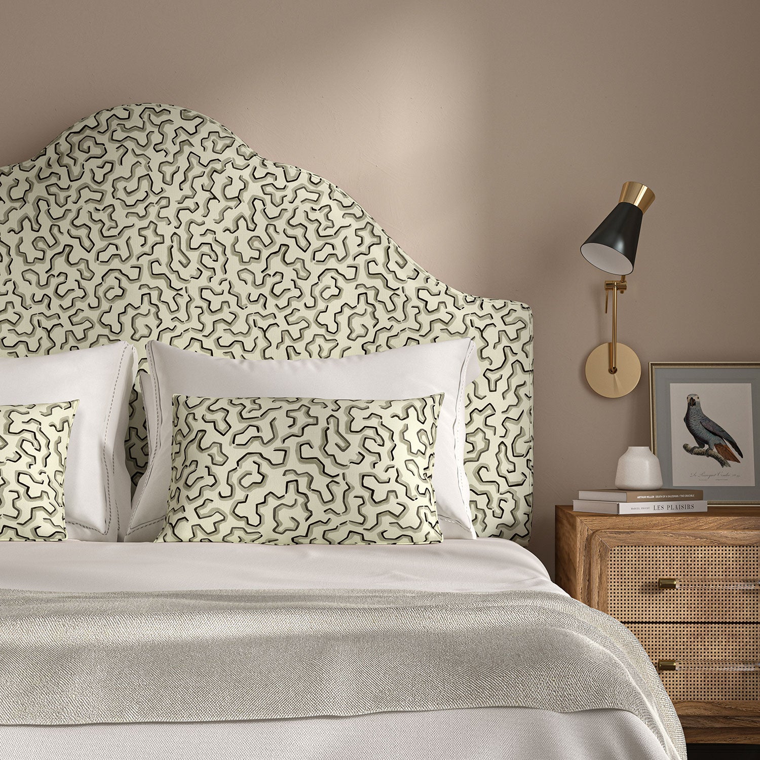 Headboard upholstered in a printed linen fabric in black, grey, and off white featuring a feel of a classic animal print.