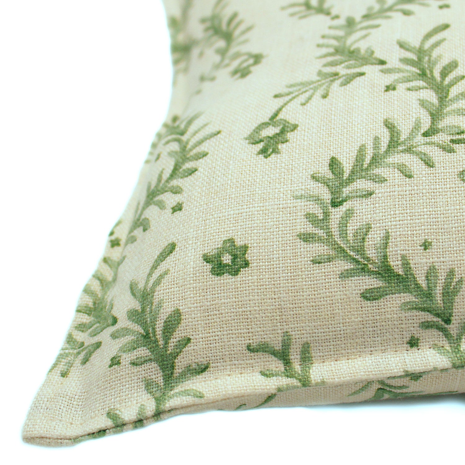 A green and cream linen cushion with a marine-style pattern.