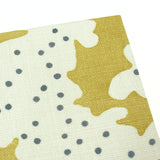 A yellow and cream linen notebook with a stylized coral pattern.