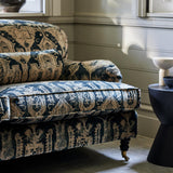 Sofa upholstered in a printed velvet fabric in brown and black featuring a Turkish kilim pattern.