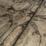 A printed velvet fabric sample in brown and black featuring a Turkish kilim pattern.