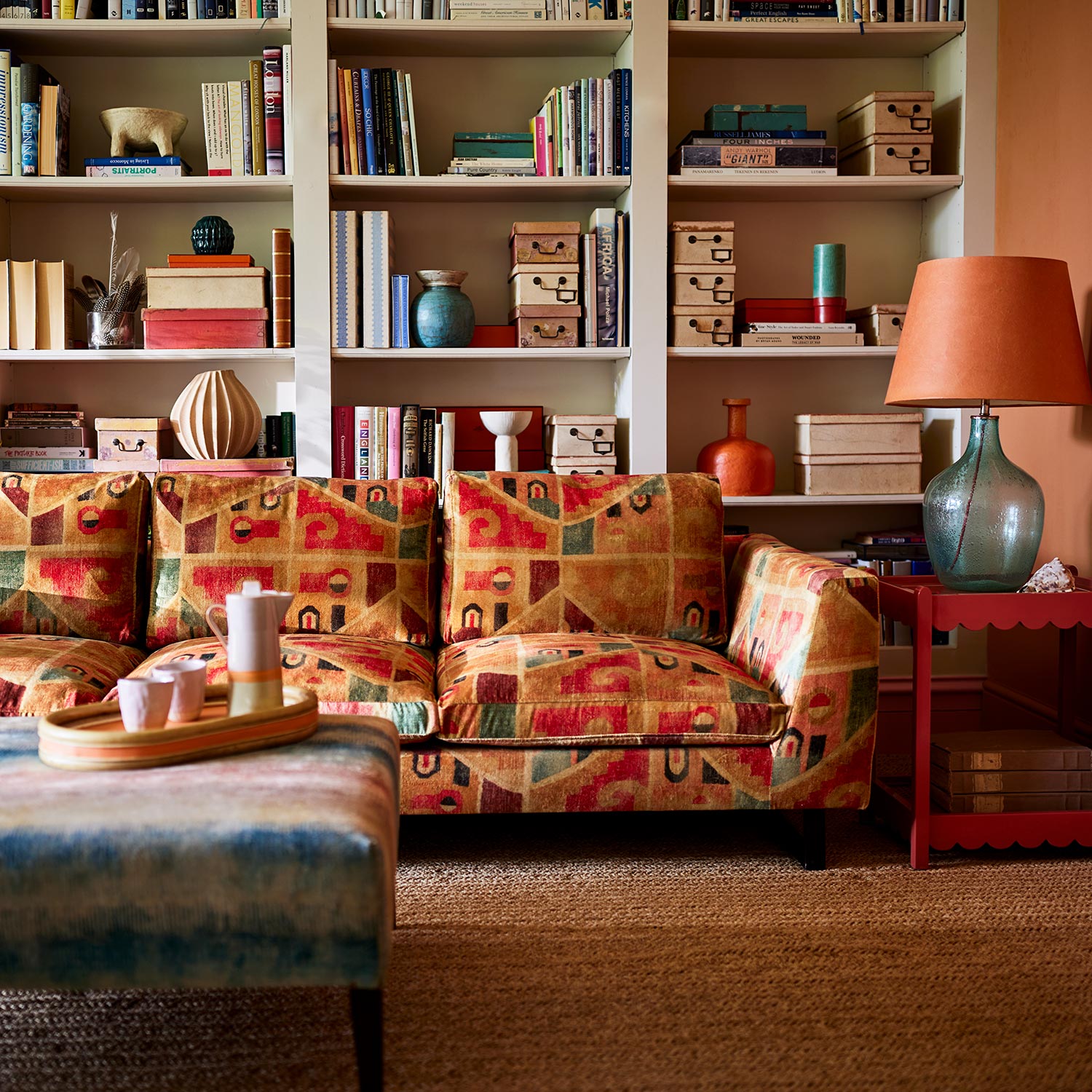 Sofa upholstered in a multicoloured printed velvet fabric featuring an abstract geometric pattern.