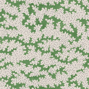 A printed linen fabric sample in green, black and off white featuring a stylized coral pattern.