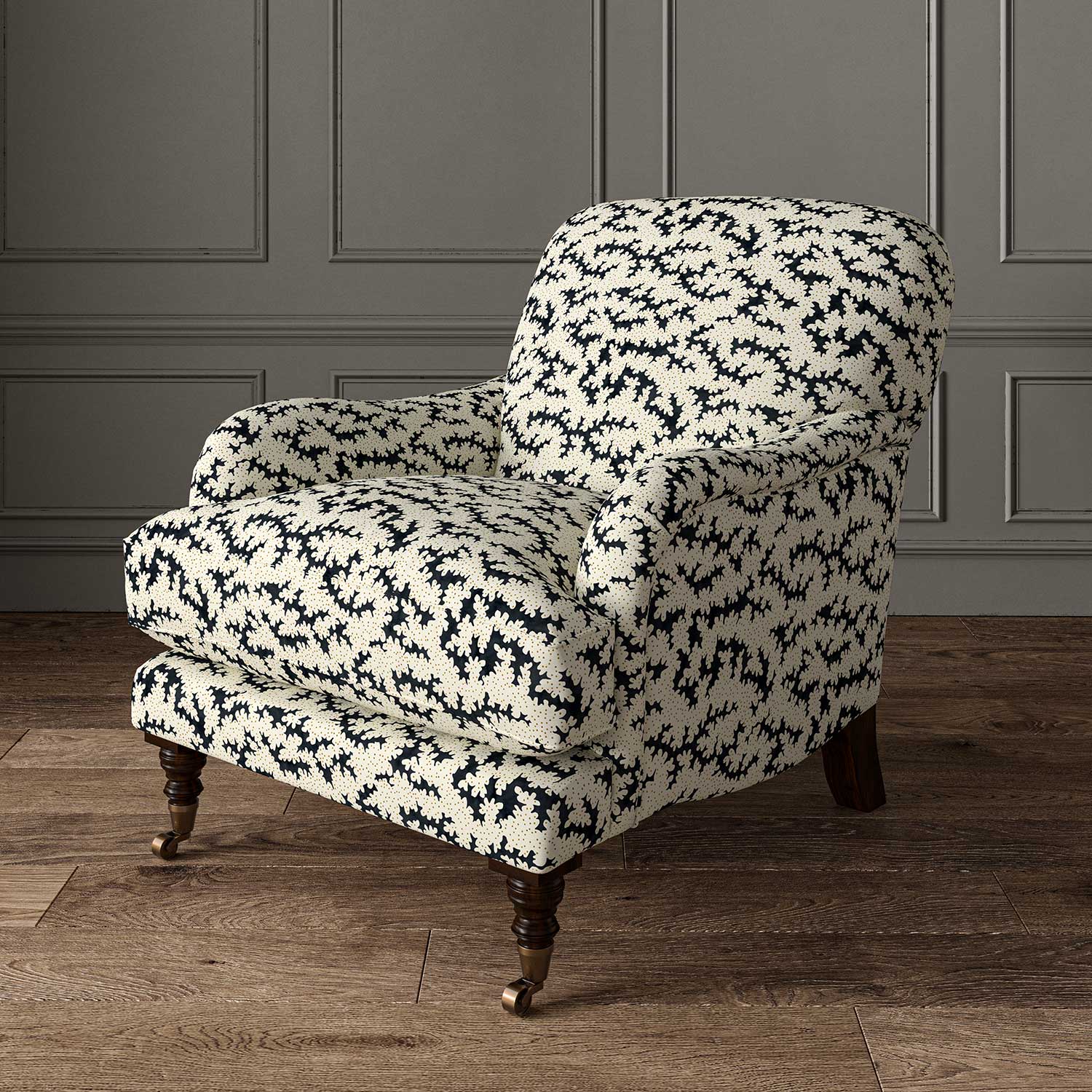 Chair upholstered in a printed linen fabric sample in black, brown and off white featuring a stylized coral pattern.