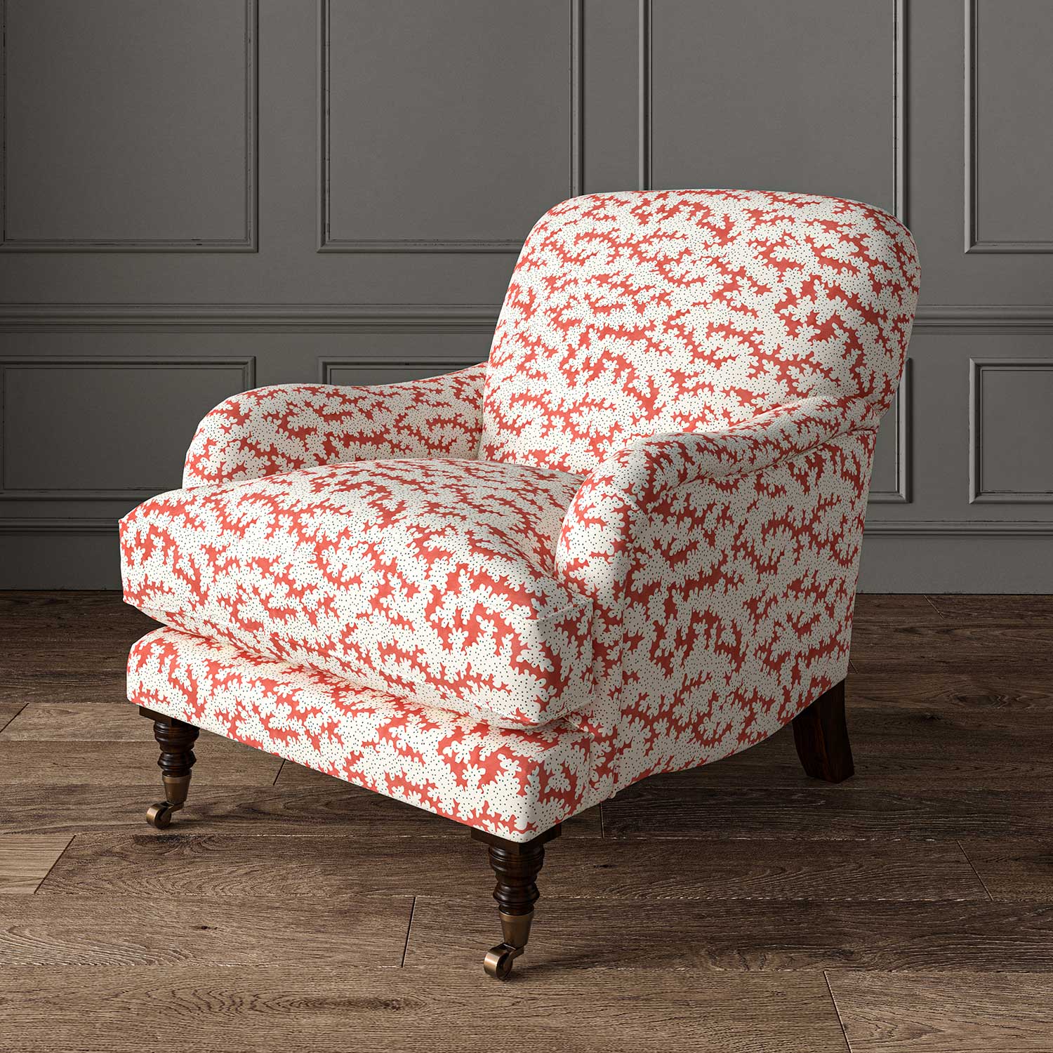 Chair upholstered in a printed linen fabric sample in red, brown and off white featuring a stylized coral pattern.