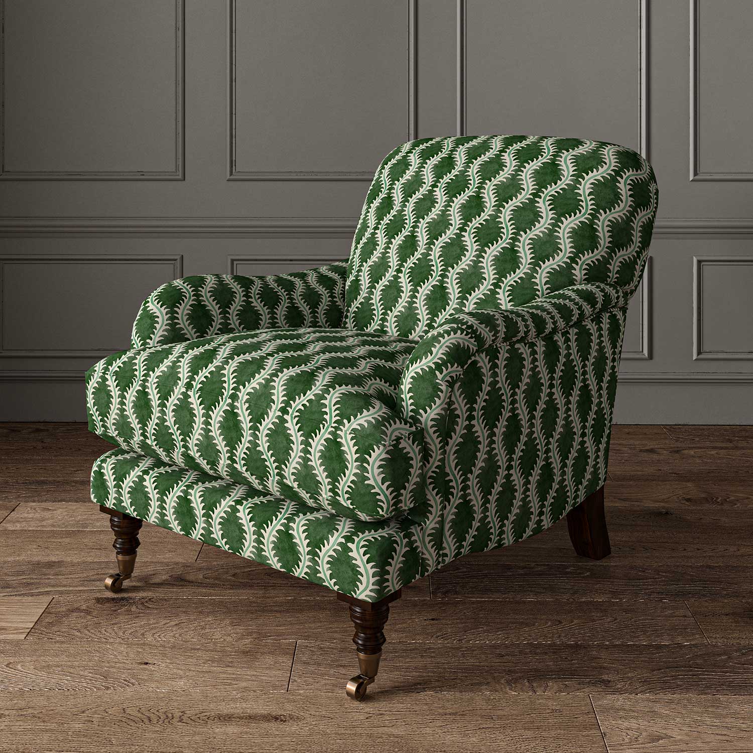 Chair upholstered in a printed linen fabric sample in green and off white featuring a stylized fern pattern.