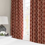 Curtains made from a printed linen fabric sample in red and pink featuring a stylized fern pattern.