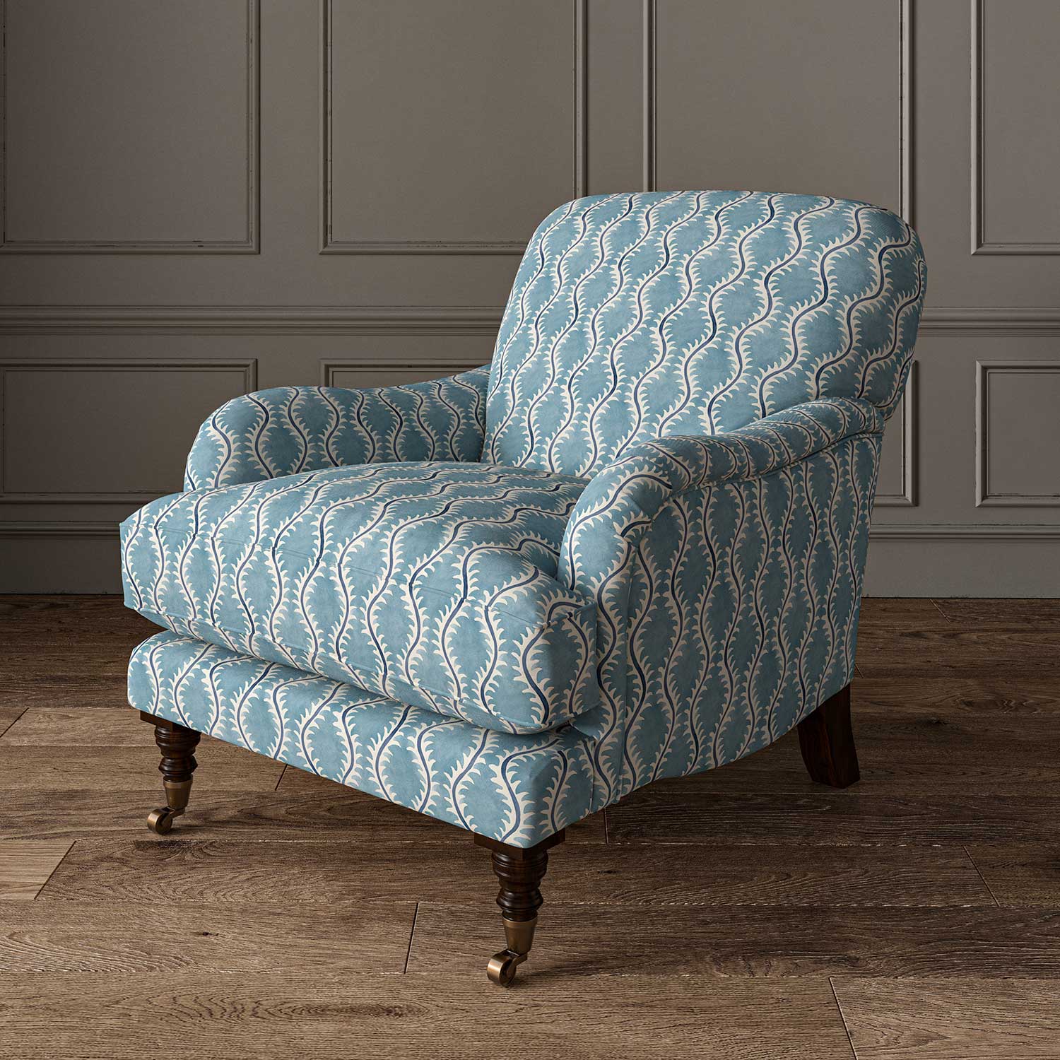 Chair upholstered in a printed linen fabric sample in blue and off white featuring a stylized fern pattern.