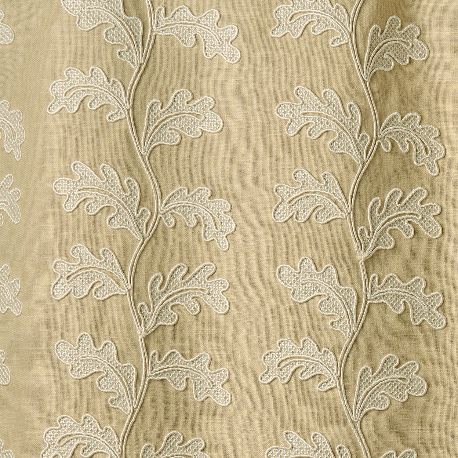 Decorative oakleaf embroidery on a beige background.