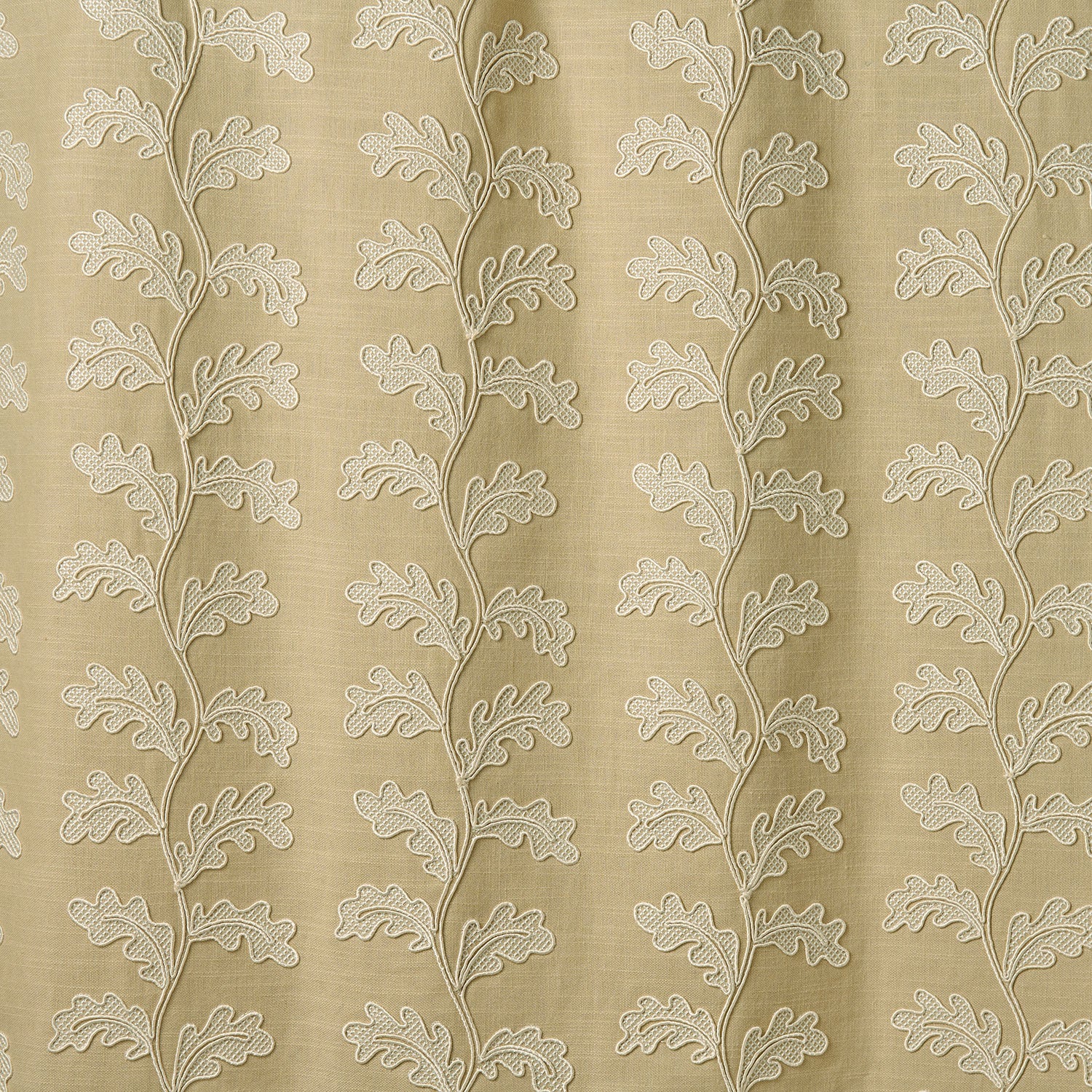 Decorative oakleaf embroidery on a beige background.