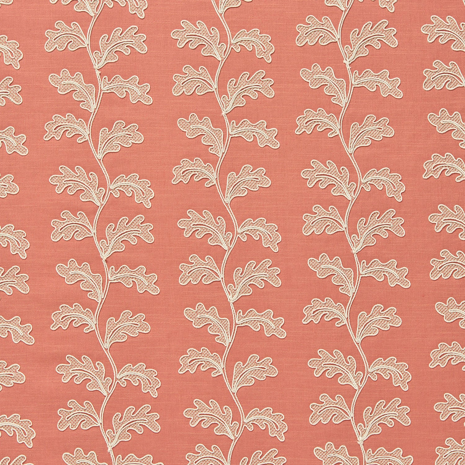 Decorative oakleaf embroidery on a coral background.