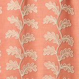 Decorative oakleaf embroidery on a coral background.