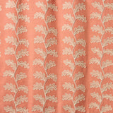 Decorative oakleaf embroidery on a coral background.