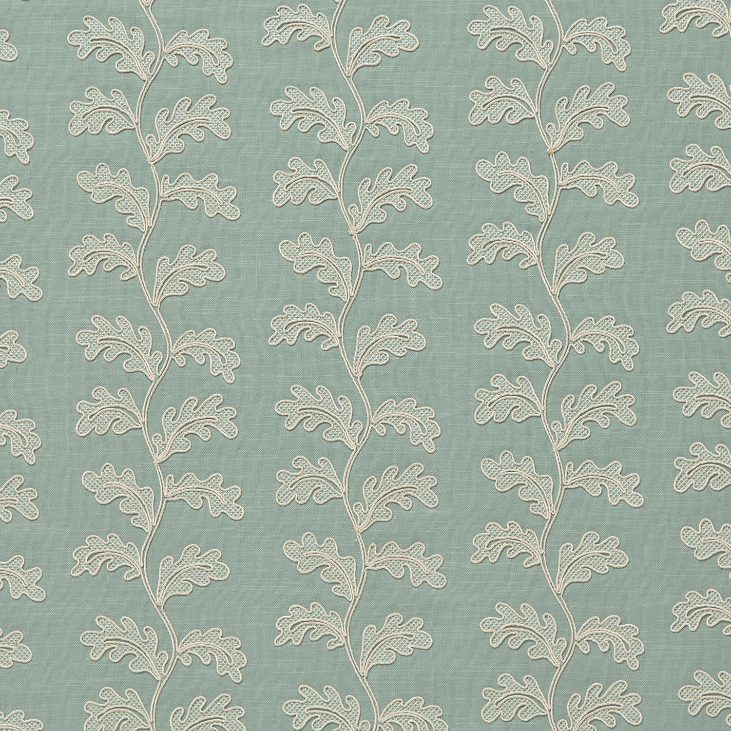 Decorative oakleaf embroidery on a blue background.