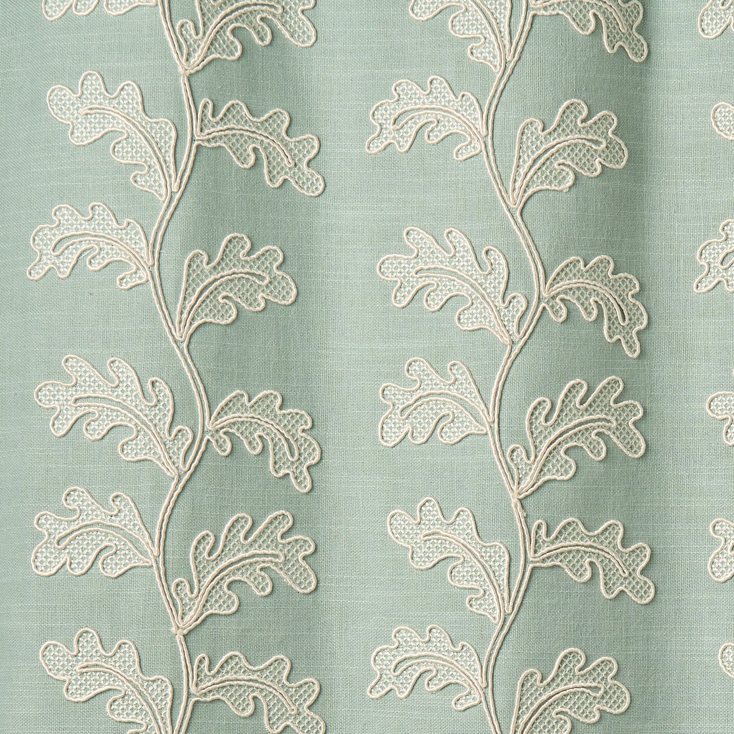 Decorative oakleaf embroidery on a blue background.