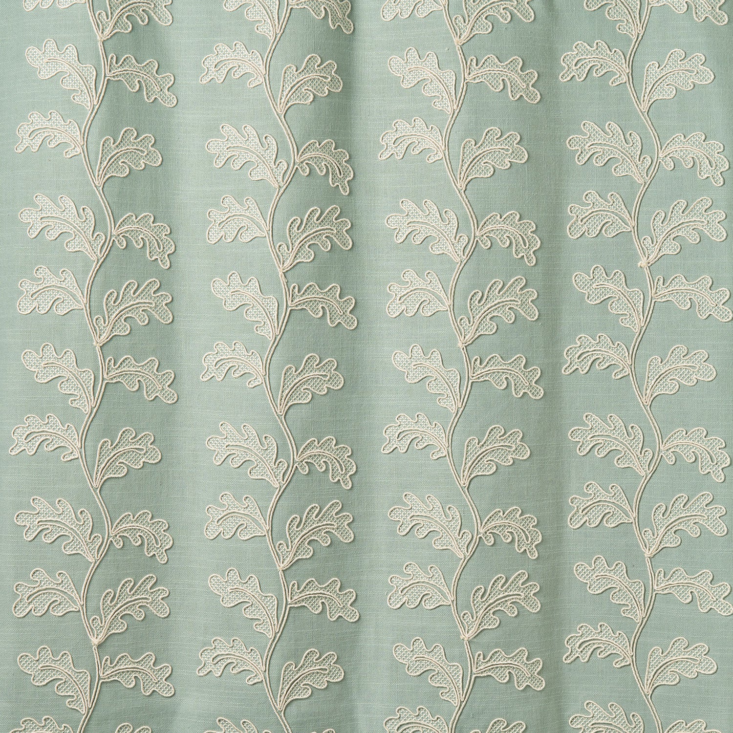 Decorative oakleaf embroidery on a blue background.