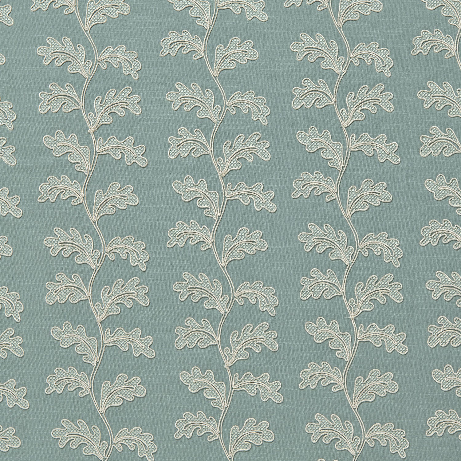 Decorative oakleaf embroidery on a blue background.