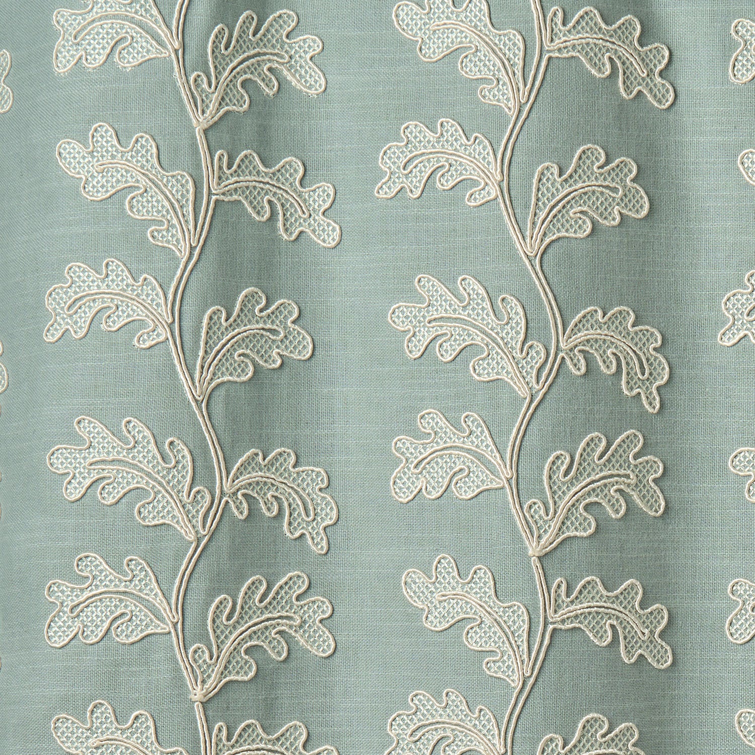 Decorative oakleaf embroidery on a blue background.