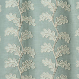 Decorative oakleaf embroidery on a blue background.