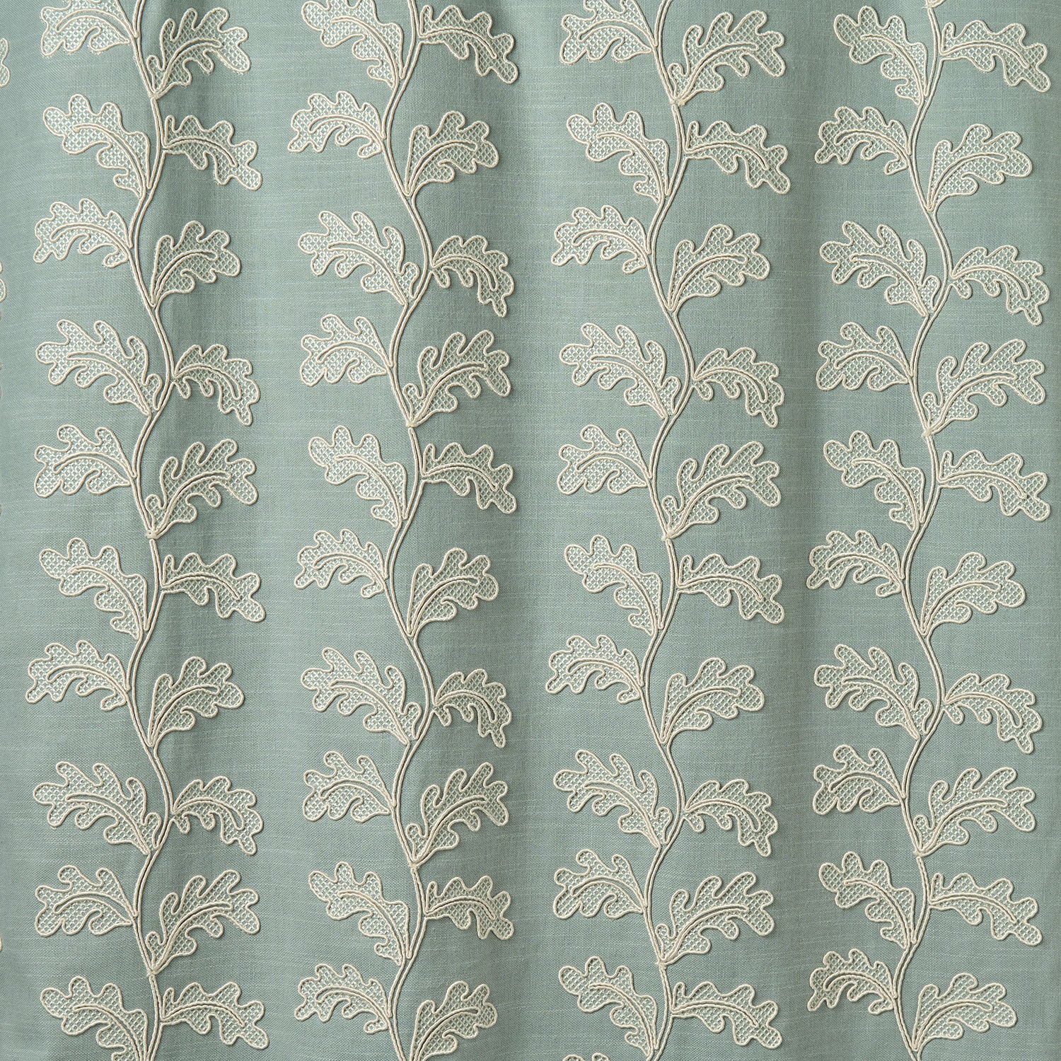 Decorative oakleaf embroidery on a blue background.
