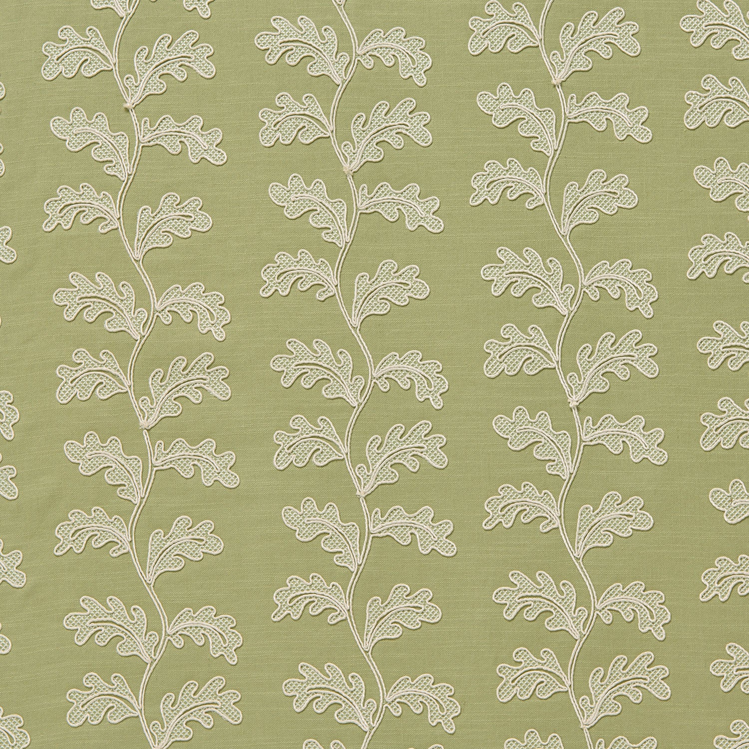 White oakleaf embroidery pattern on a green background.