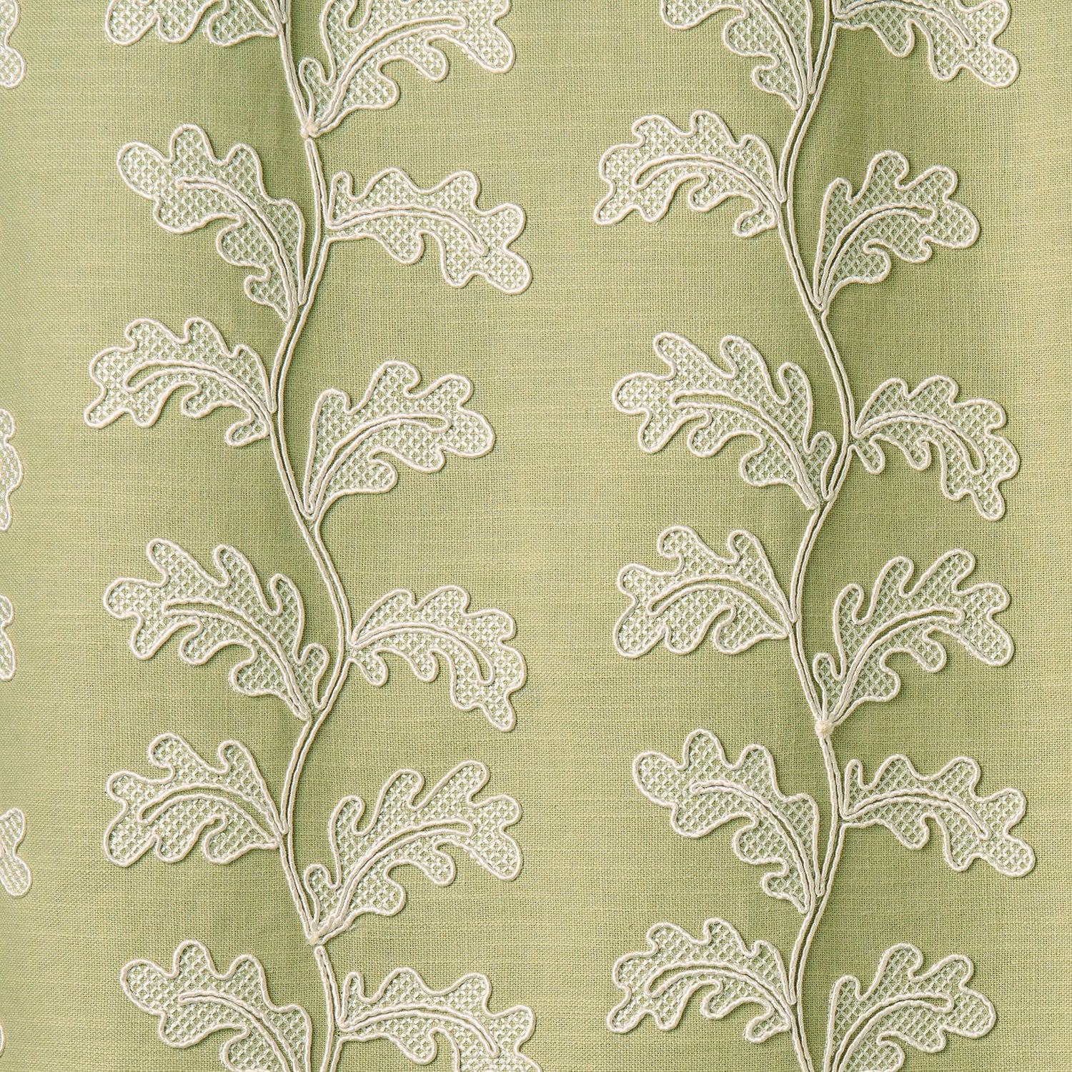 White oakleaf embroidery pattern on a green background.