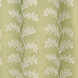 White oakleaf embroidery pattern on a green background.