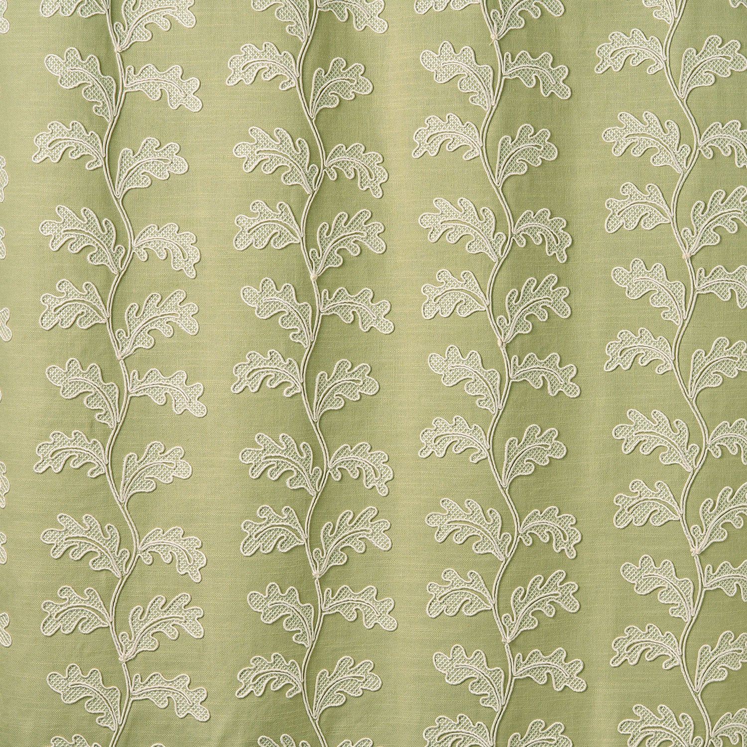 White oakleaf embroidery pattern on a green background.