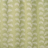 White oakleaf embroidery pattern on a green background.