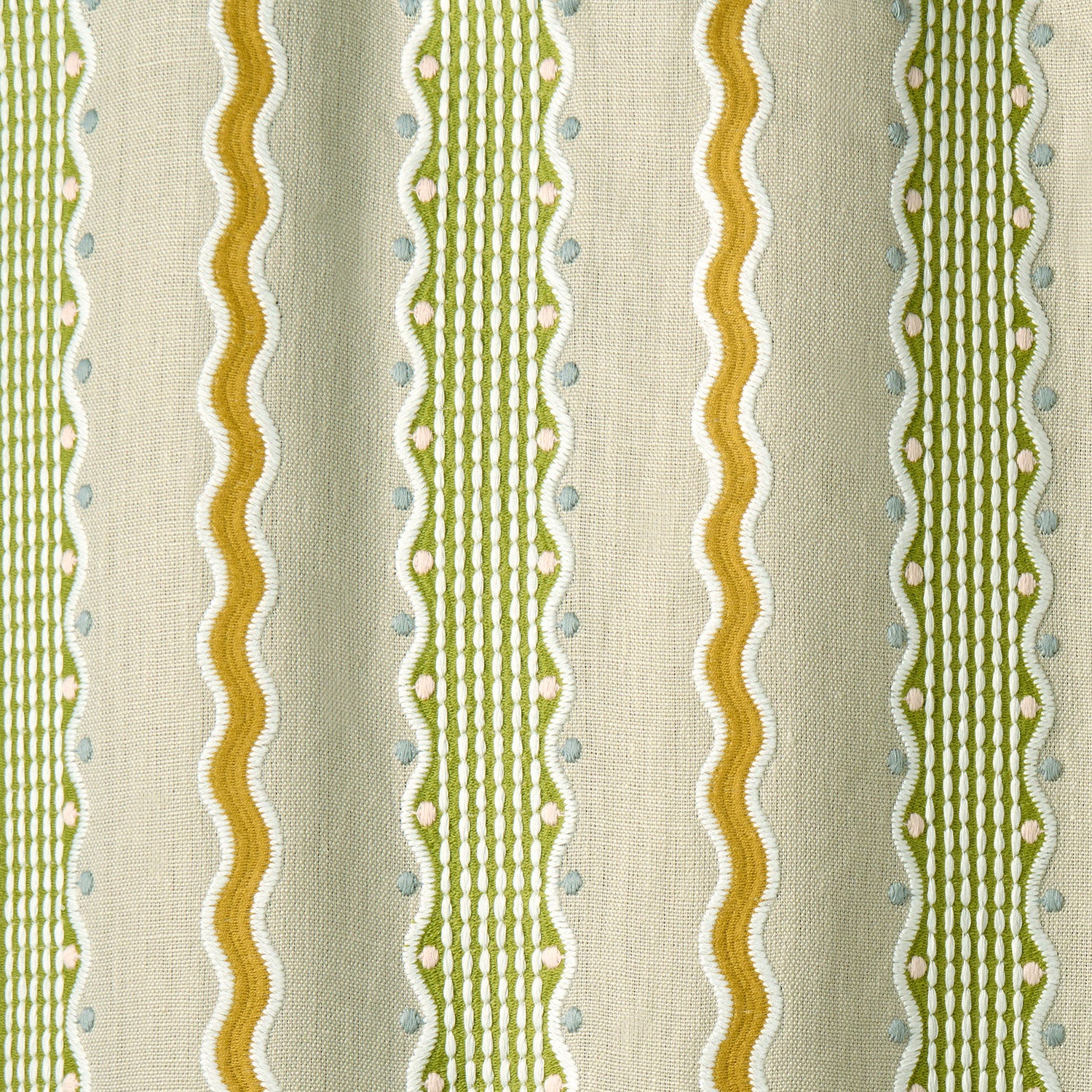 Patterned embroidered fabric with green and gold stripes on a beige background.
