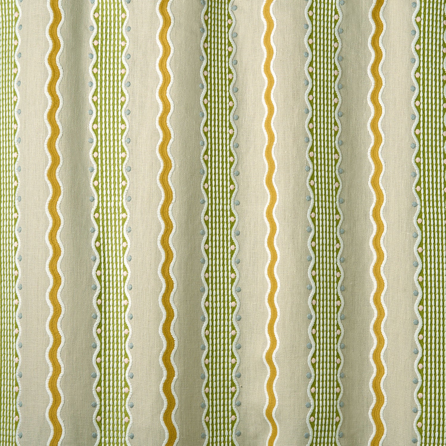 Patterned embroidered fabric with green and gold stripes on a beige background.