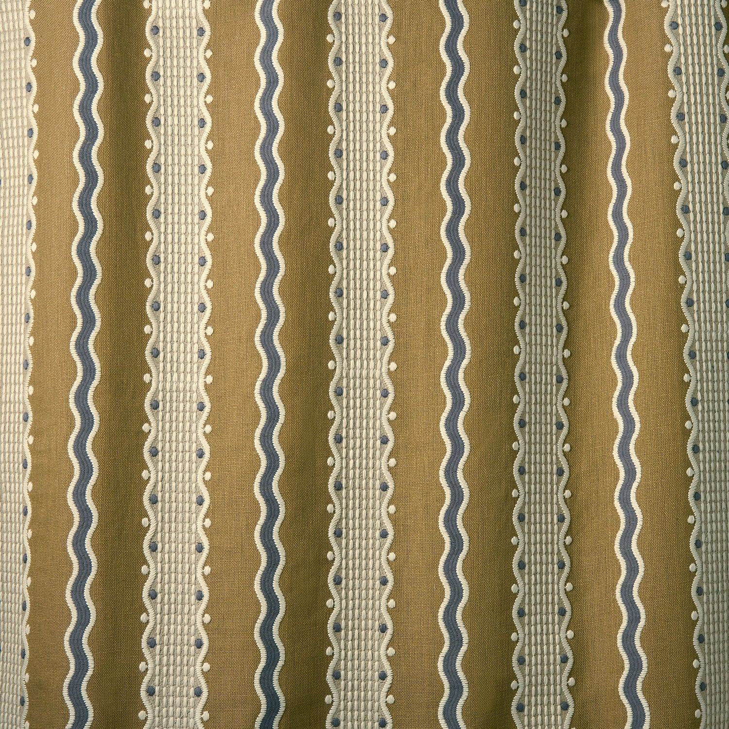 Embroidery fabric with wavy lines and small dots on a brown background.