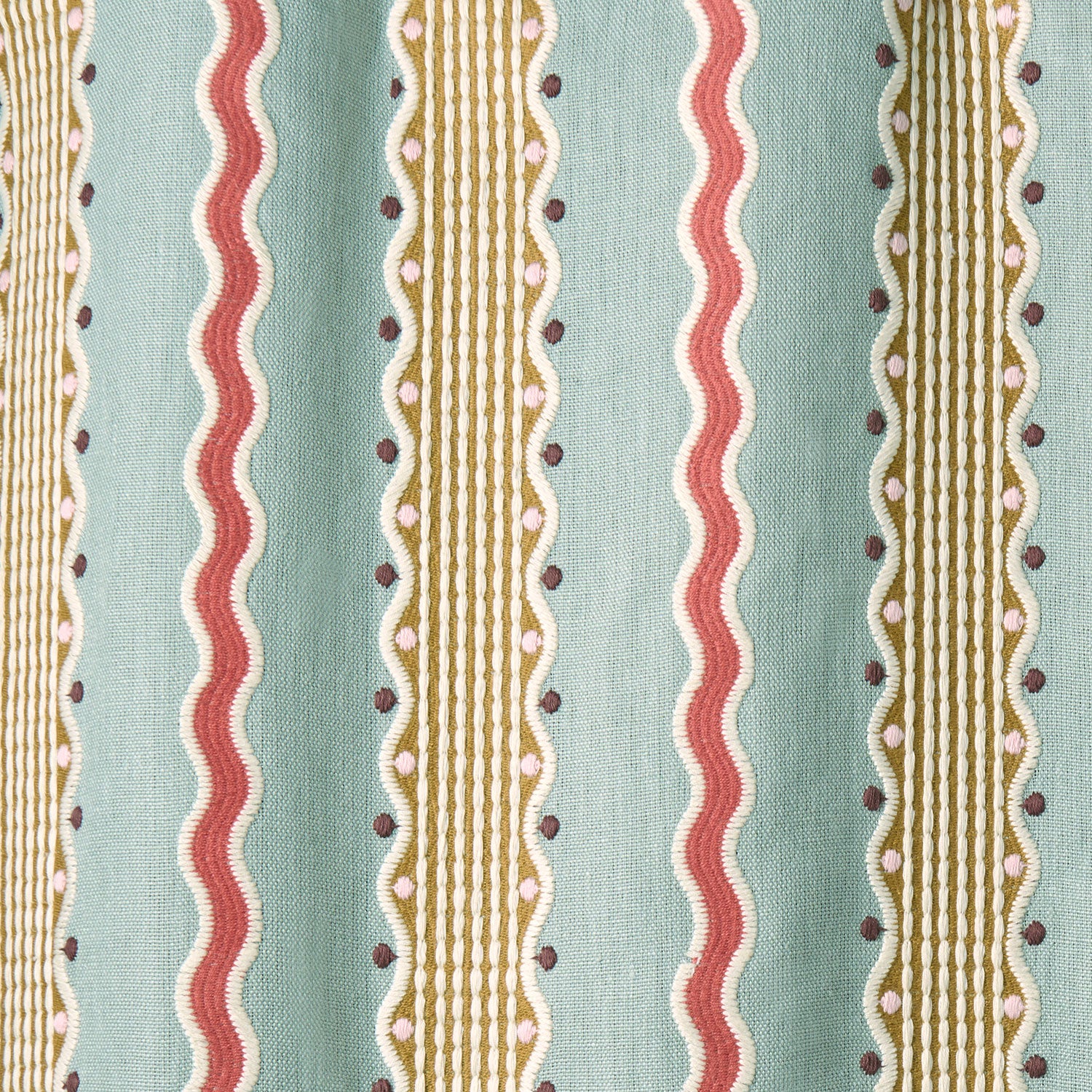 Embroidery fabric with vertical stripes in red, beige, and brown on a light blue background.