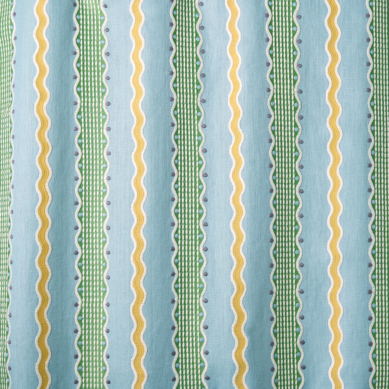 Embroidery fabric with green and yellow stripes on a blue background.