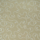 White embroidery pattern on a taupe background.