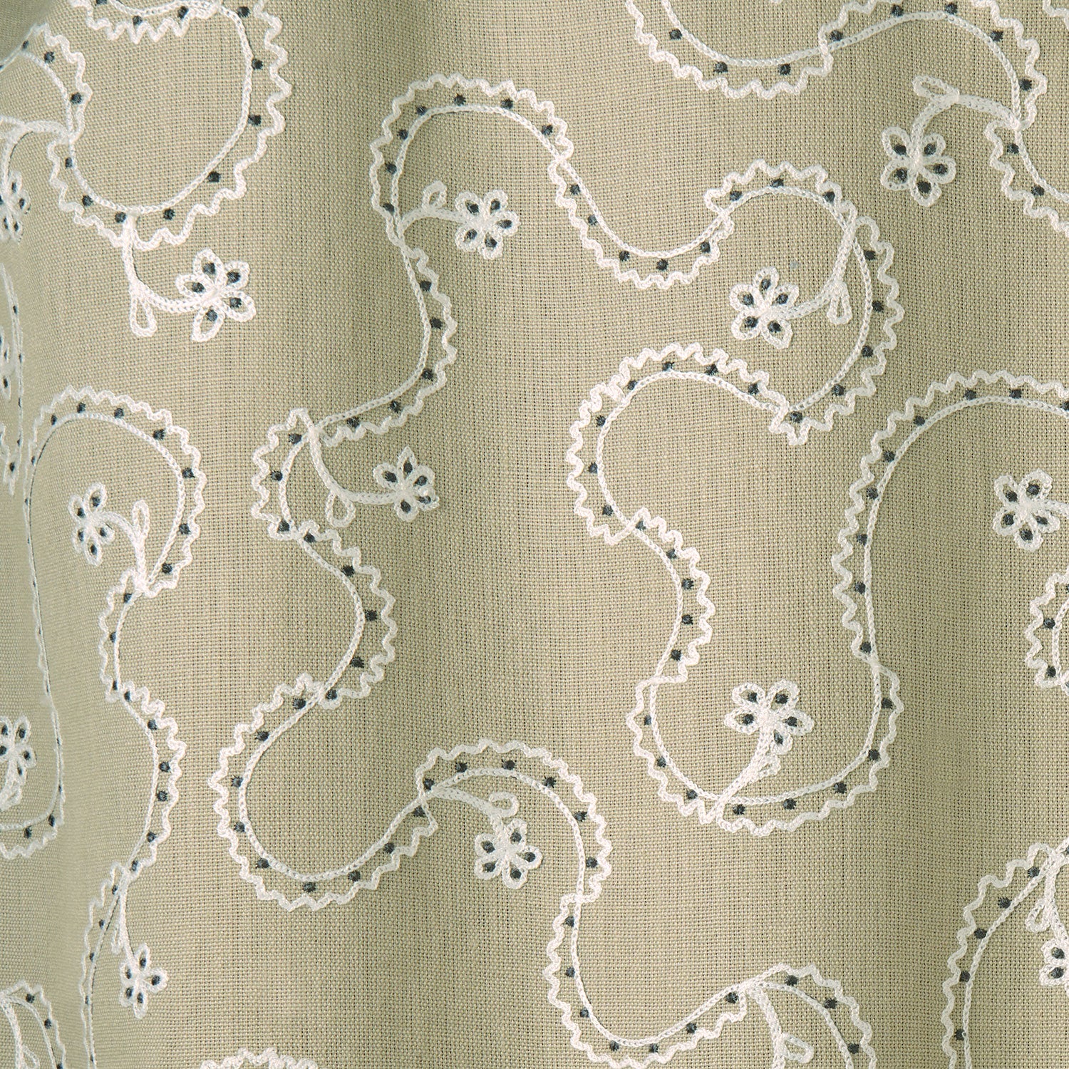 White embroidery pattern on a taupe background.