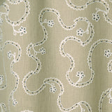 White embroidery pattern on a taupe background.