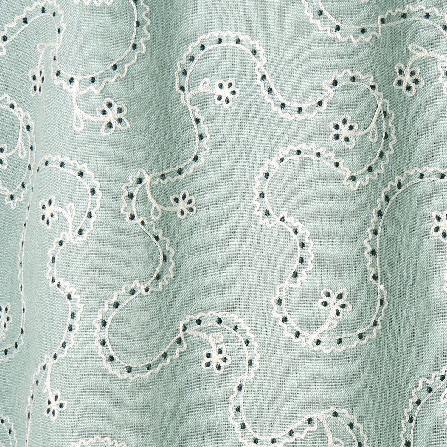 White embroidery pattern on a light blue background.