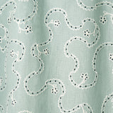 White embroidery pattern on a light blue background.