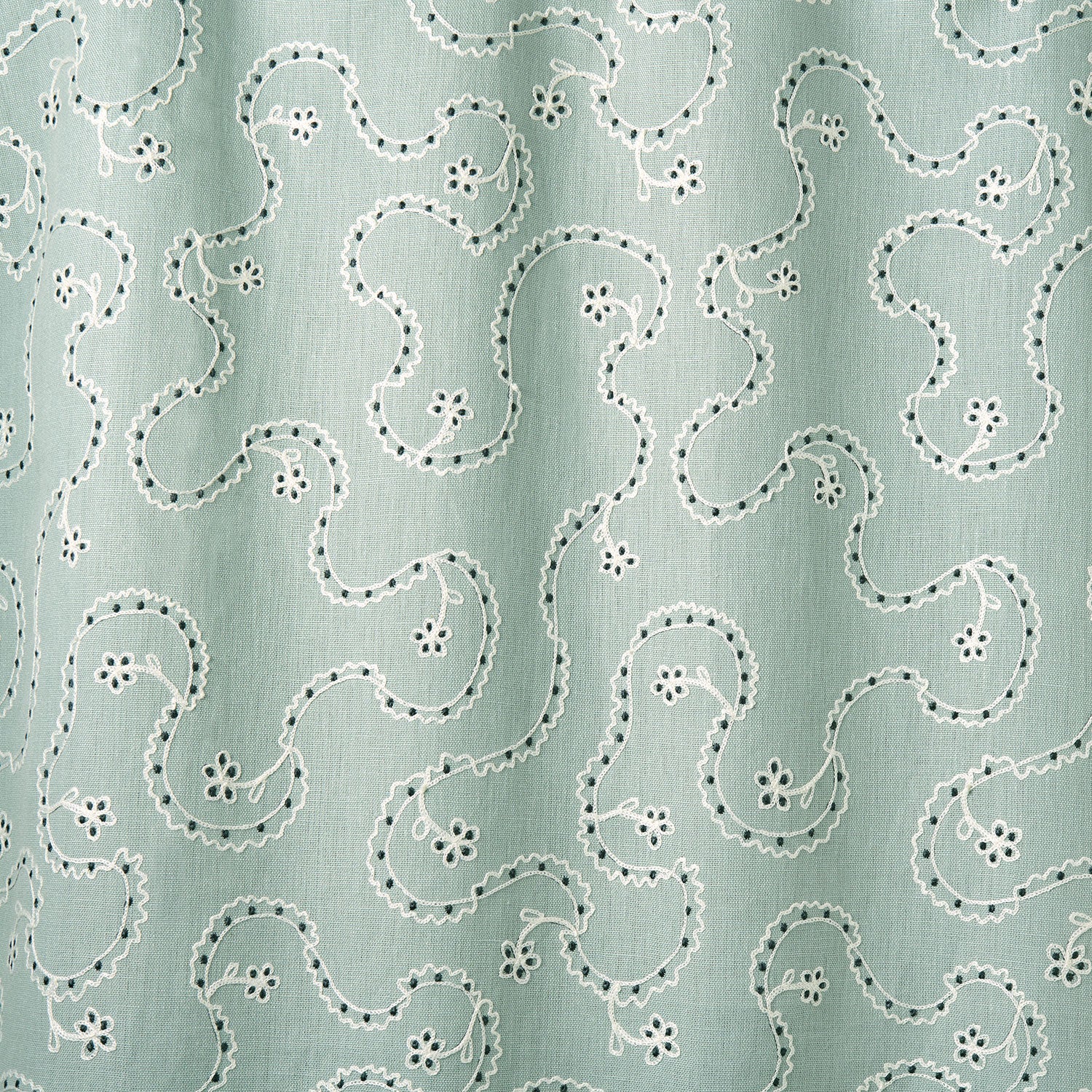 White embroidery pattern on a light blue background.