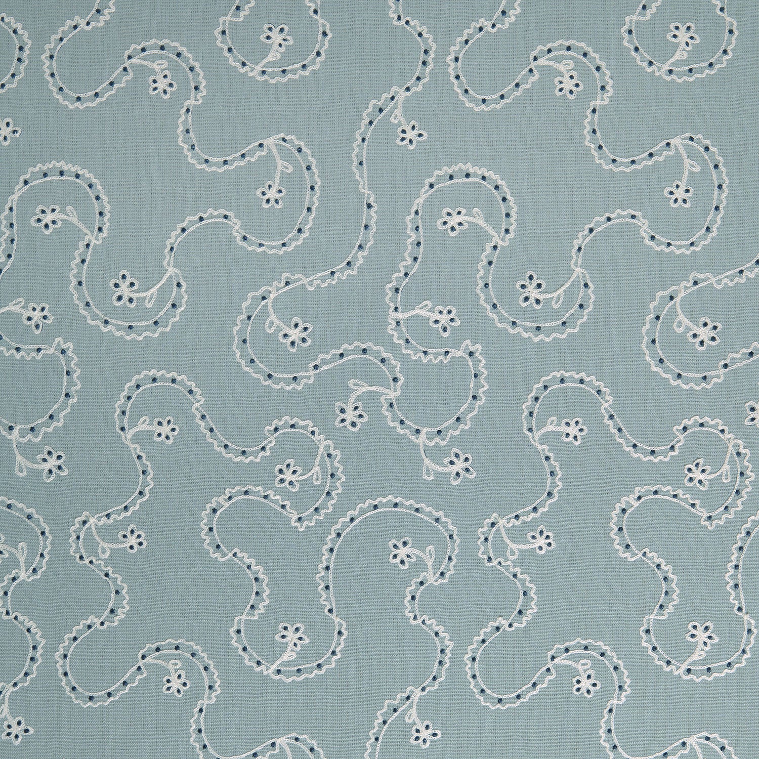 White embroidery pattern on a blue background.